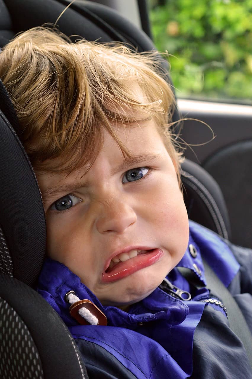 Baby boy upset in a car seat upset
